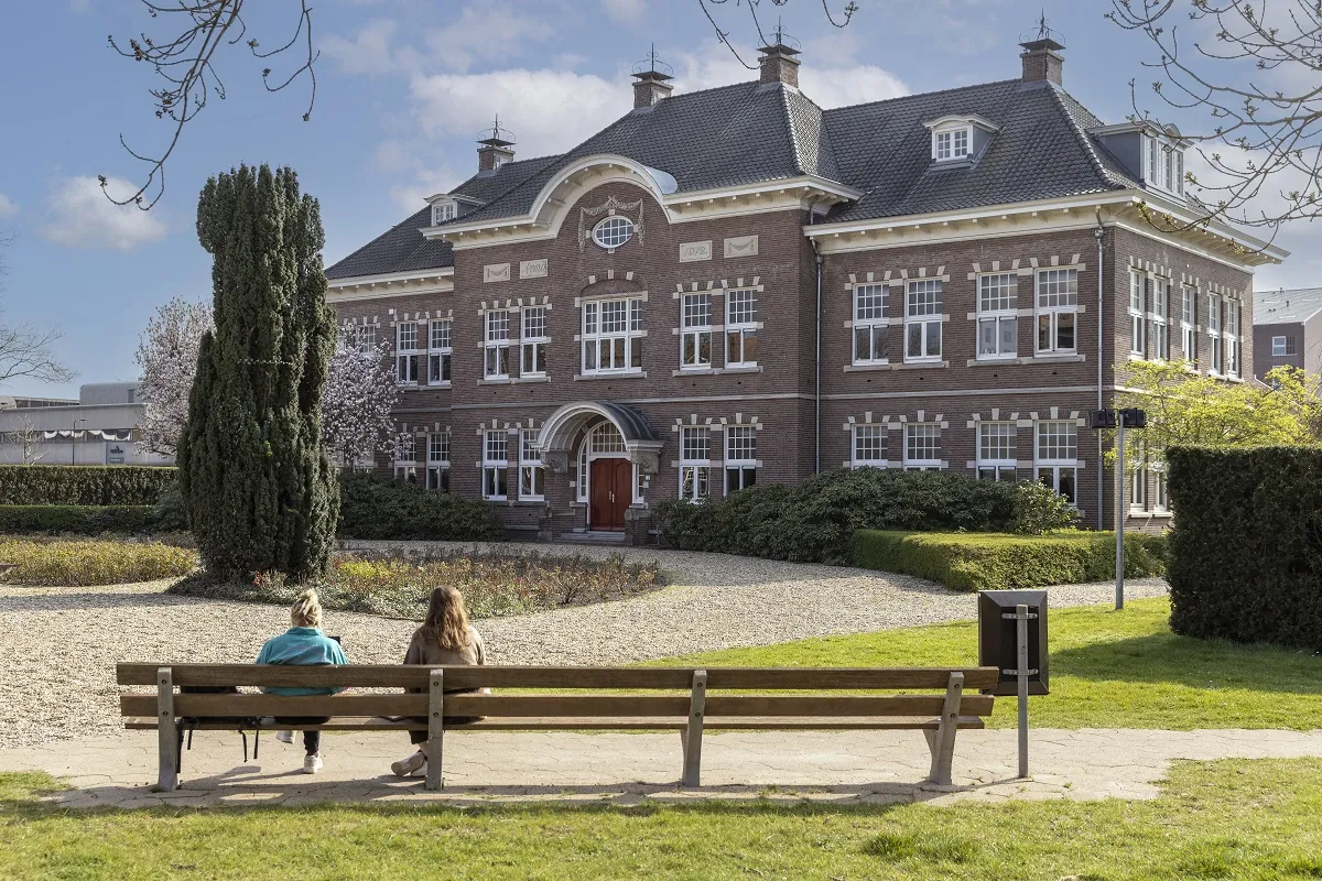 University College Utrecht campus building with greenery and outdoor seating