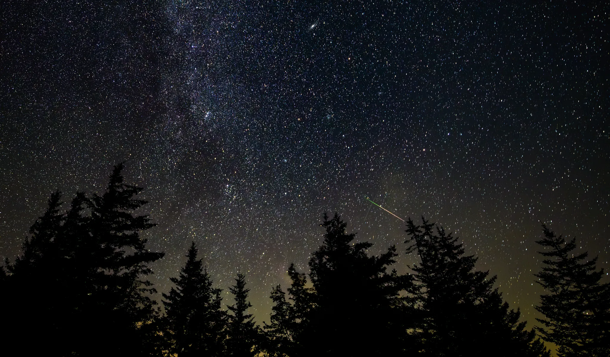 Perseid meteors streaking across a dark, star-filled sky