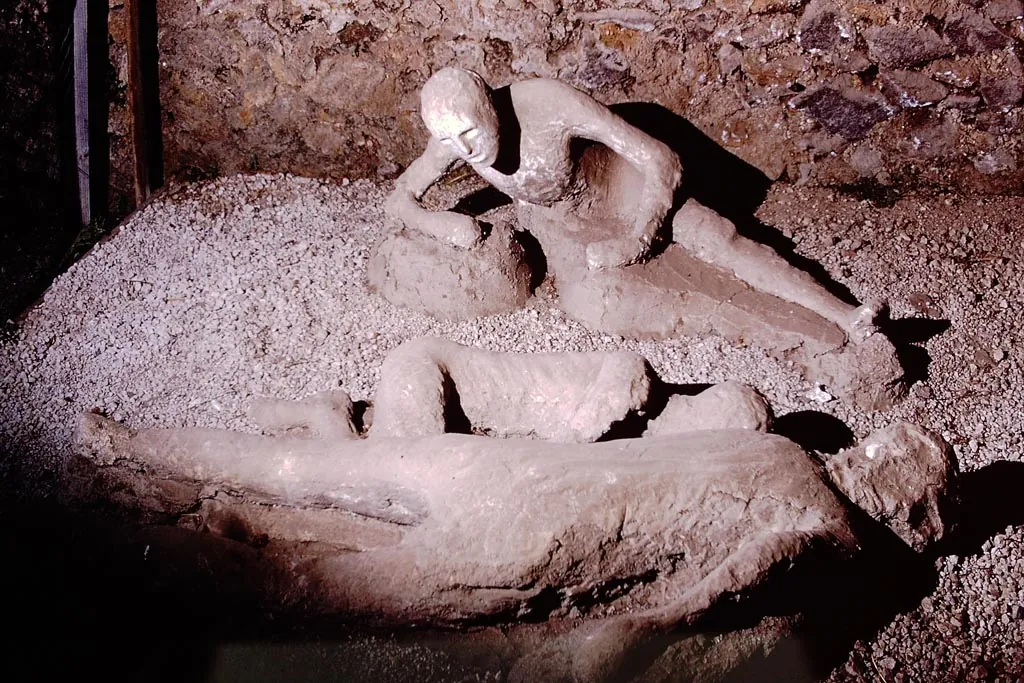 Thirteen plaster body casts lying in the Garden of the Fugitives at Pompeii