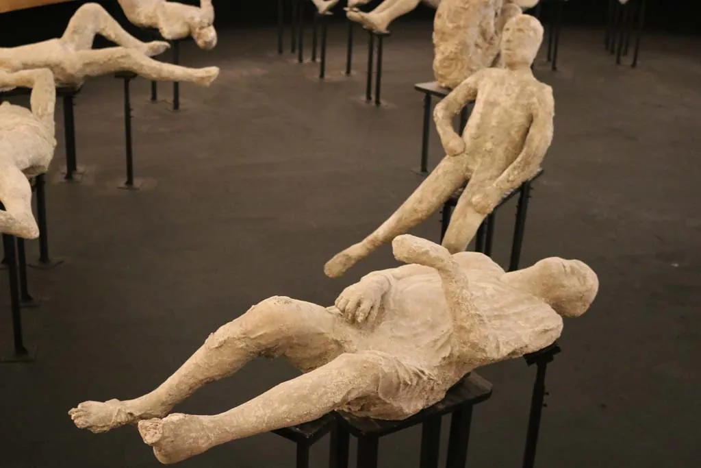 Plaster cast of the Heavily Clothed Man showing fabric textures and a curled body position