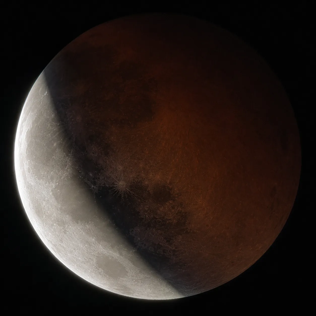 Telescope view of a deep partial lunar eclipse with the umbral shadow crossing lunar craters and a bright ray crater near the shadow boundary