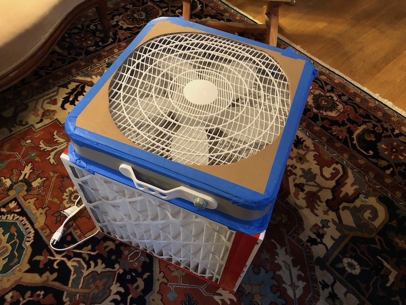 A Corsi-Rosenthal cube air cleaner built from four filters and a box fan.