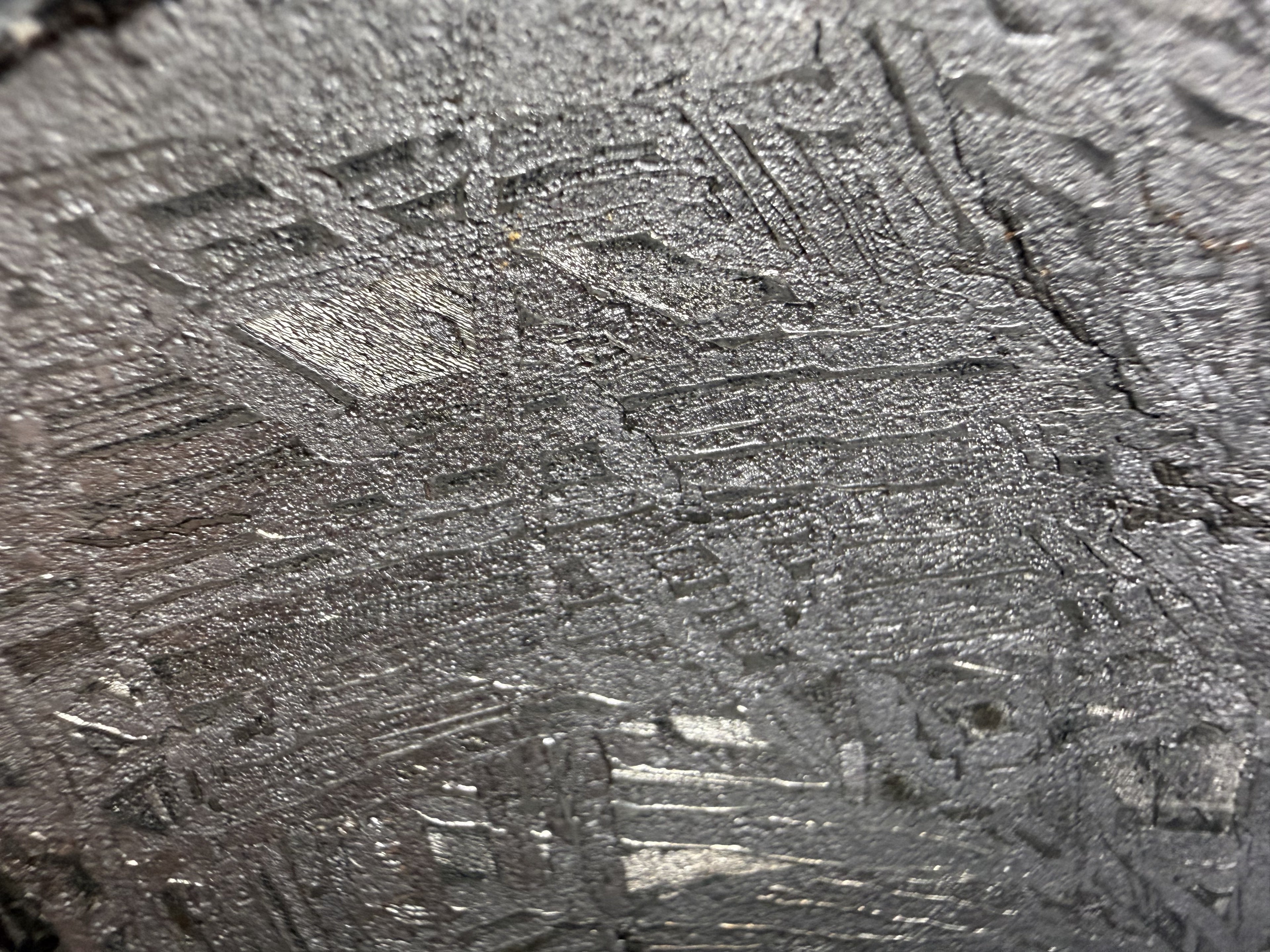 Etched iron meteorite slice showing a geometric Widmanstatten pattern of kamacite and taenite bands