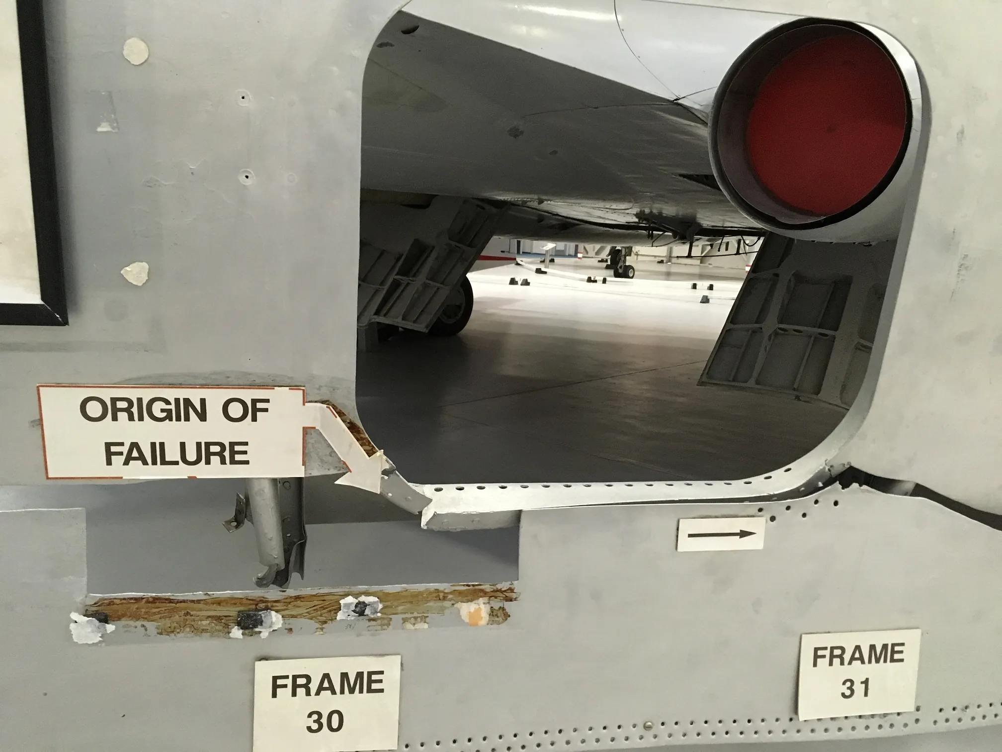 Recovered De Havilland Comet fuselage panel showing a fatigue fracture near a window corner area
