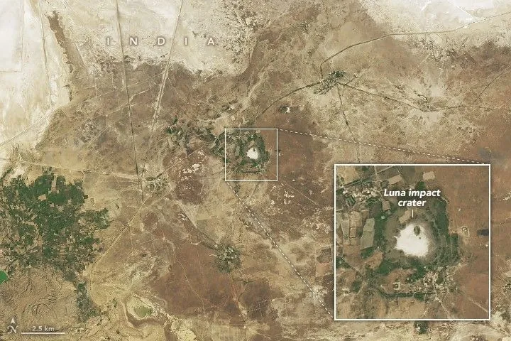Satellite image of Meteor Crater in Arizona with a raised rim in flat desert terrain