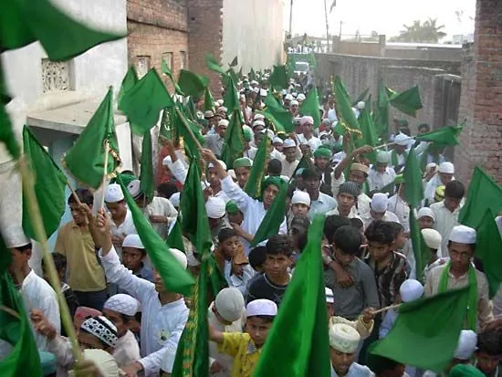 A contemporary Mawlid procession with crowds and banners in Bhadohi, Uttar Pradesh, India