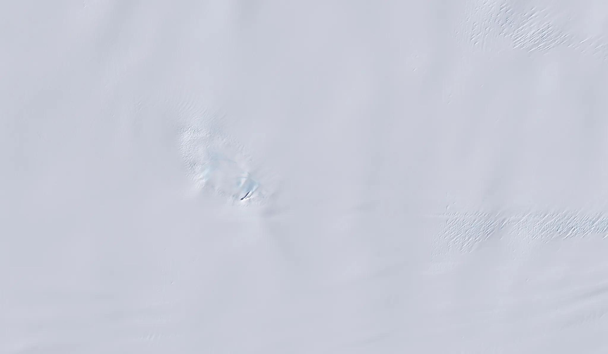 Landsat optical image of the same Antarctic nunatak showing a bright white surface with little visible crevasse structure