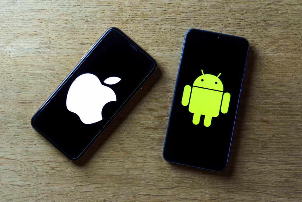 An iPhone and Android phone shown side by side with data transfer indicators